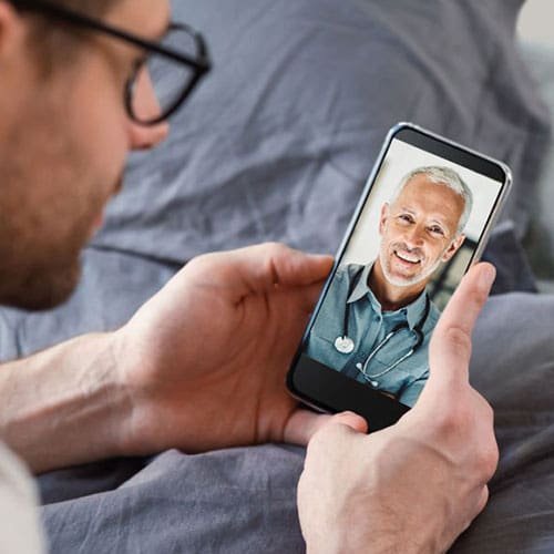 a male having a Telehealth consultation