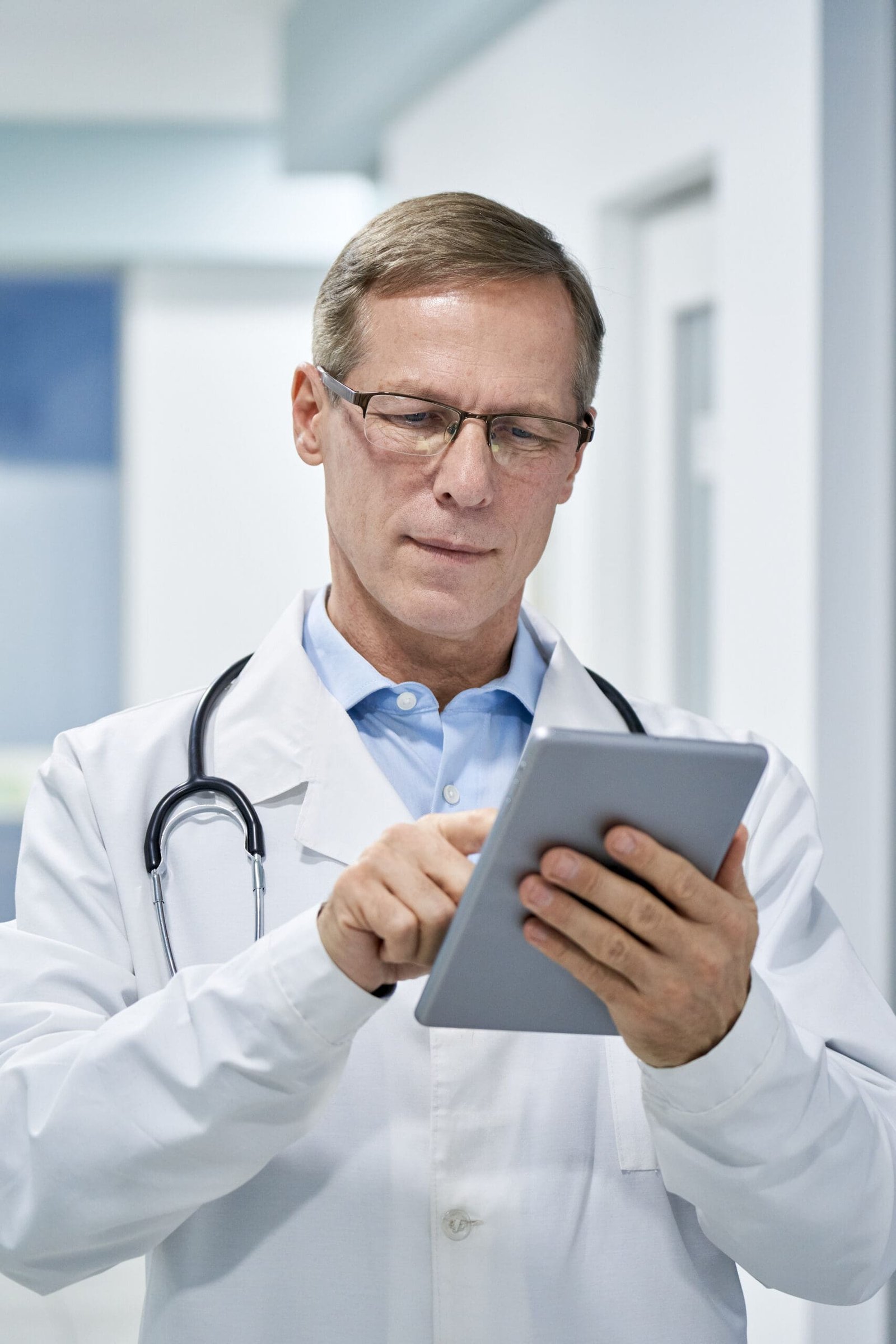 Doctor checking tablet for his patient appointments