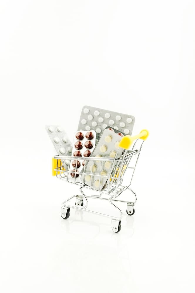 Medications in a shopping trolly with white background